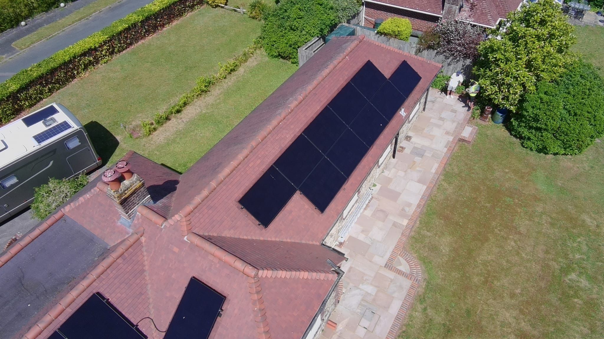 Aerial view of a bungalow with arrays on several roof slopes