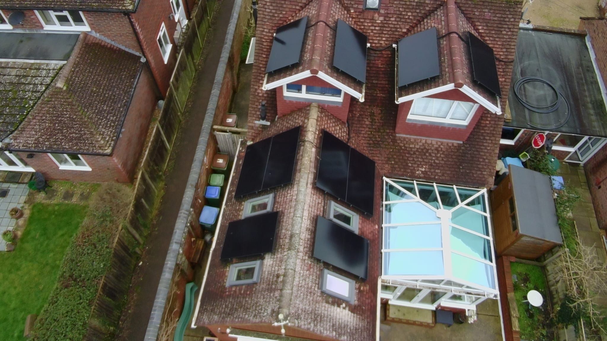 Panels fitted between dormers and roof windows on a steep tiled roof, seen from above