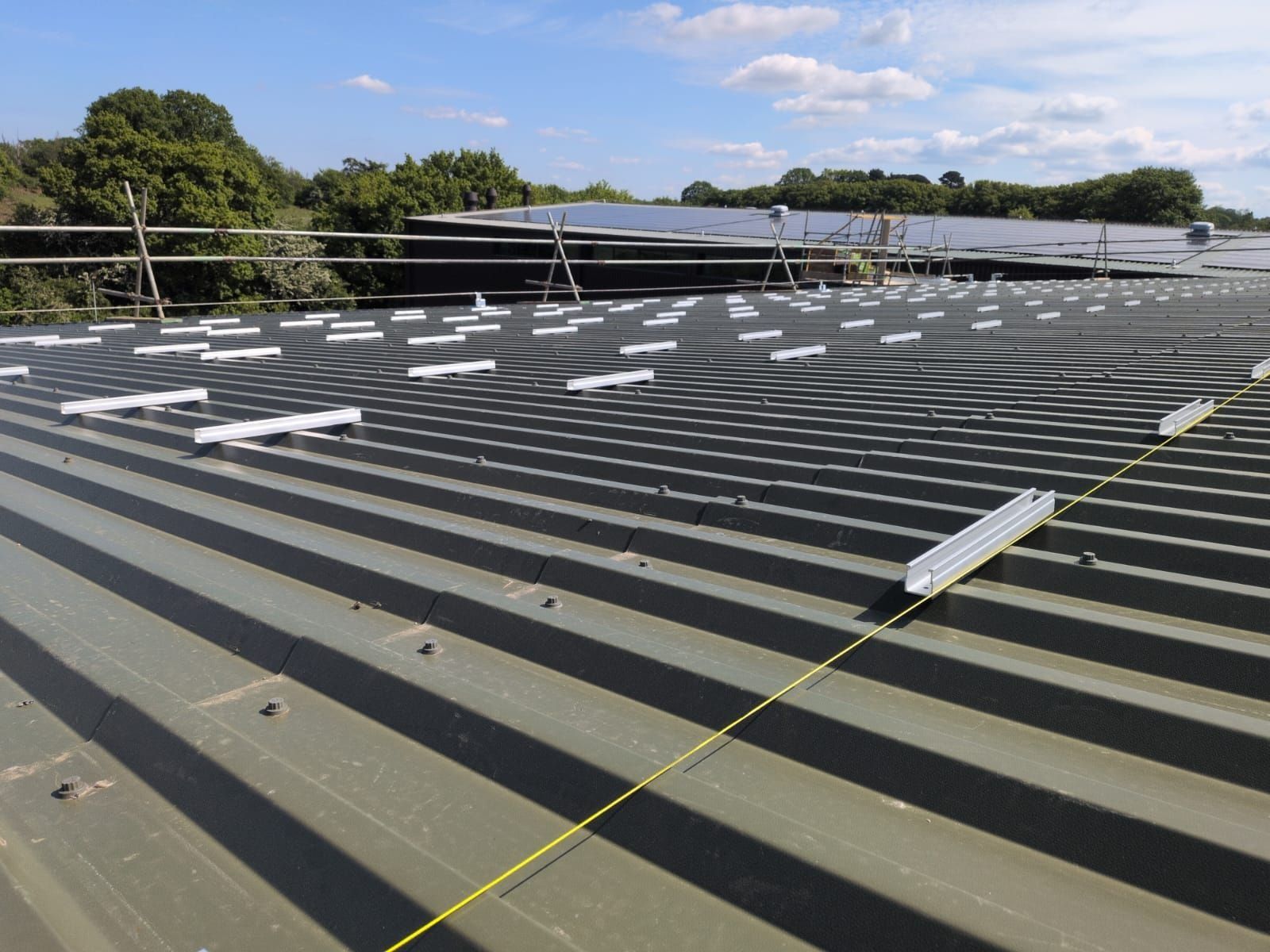 Mounting brackets set out along a string line on a steel roof
