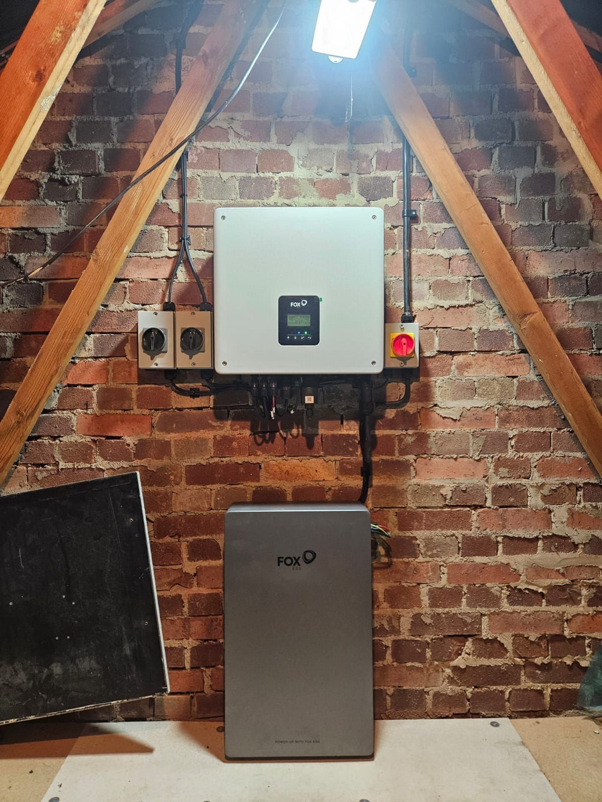 A home battery and inverter installed in a loft under the rafters