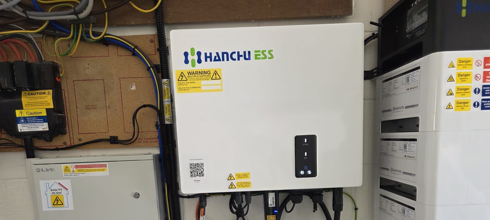 A Hanchu ESS inverter beside a stacked Hanchu battery, installed by Solar Squirrel