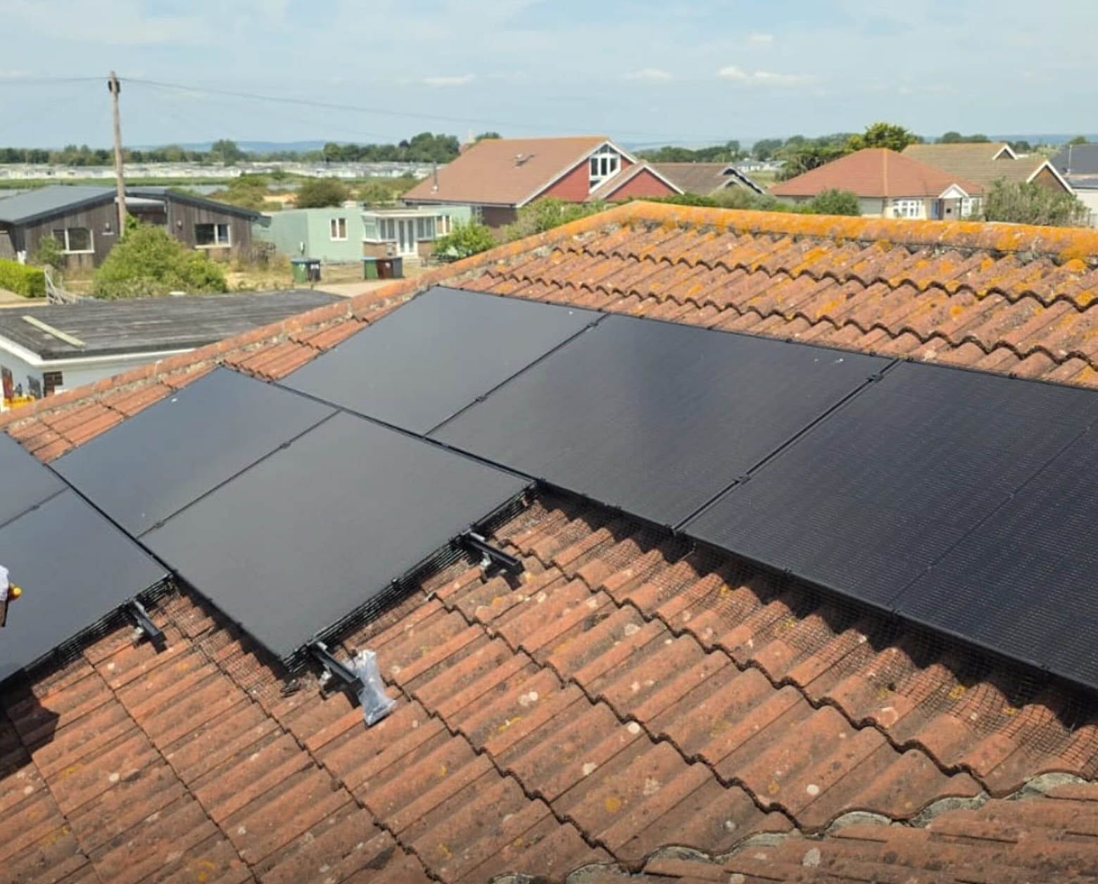 All-black solar panels on a red-tiled roof